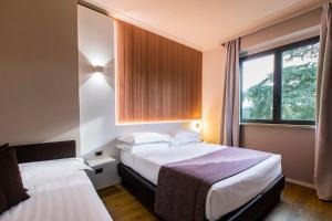 Postel nebo postele na pokoji v ubytování Garner Hotel Rome Aurelia by IHG + 37 fotografií