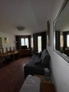 a living room with a couch and a table at Canigou 17 by Confortsky in Pas de la Casa