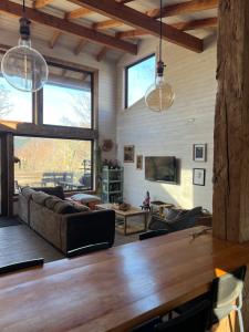 a living room with a large wooden table at Refugio Vista Sierra Nevada in Malalcahuello