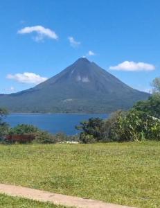 a mountain with a lake in front of it at Arenal Base Camp in El Castillo de La Fortuna