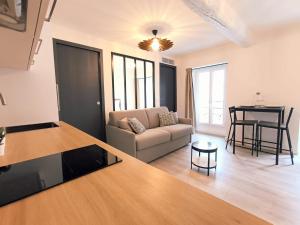a living room with a couch and a table at Seytour Central Place in Nice +8 photos