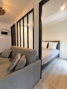 a living room with a couch and a bed at Seytour Central Place in Nice