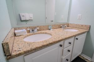 a bathroom with two sinks and a large mirror at Meridian Plaza 307! Third Floor Ocean Views! Sleeps 4! in Myrtle Beach +55 photos
