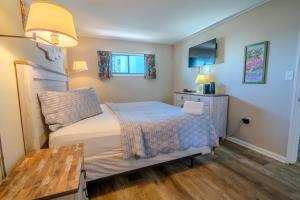 a small bedroom with a bed and a table at Meridian Plaza 307! Third Floor Ocean Views! Sleeps 4! in Myrtle Beach
