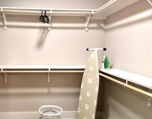 a walk in closet with a shelf and a curtain at Beautiful 1BR - Fitness & Pool in Austin