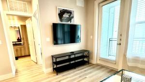 a living room with a flat screen tv on a wall at Beautiful 1BR - Fitness & Pool in Austin