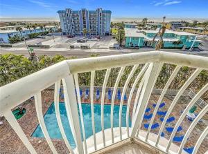 a balcony with a view of a pool at Shore Thing in St. Pete Beach