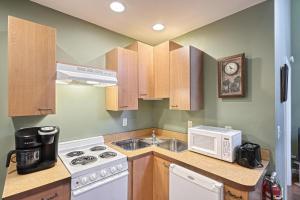 a kitchen with a sink and a microwave at Suites On Chocolate - The Zoo in Hershey