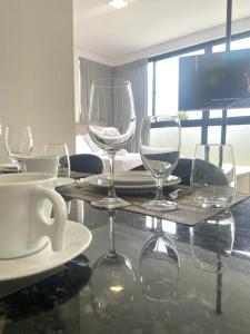 a table with wine glasses sitting on top of it at Loft Bamberg 101 in Pomerode