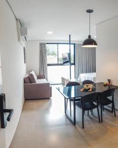 a living room with a dining room table and a couch at Loft Bamberg 101 in Pomerode