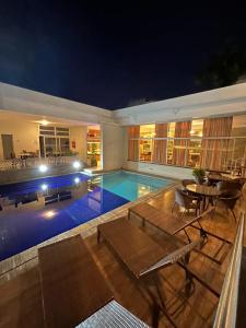 a house with a swimming pool at night at Arituba Park Hotel in Natal