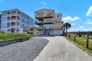 a large apartment building with a walkway at 116 Scotch Bonnet Drive - Better Together in North Topsail Beach