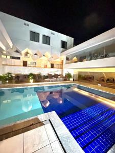 a swimming pool at night with a house at Arituba Park Hotel in Natal