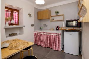 a small kitchen with a table and a microwave at Κυκλαδίτικο Studio in Kionia +15 photos