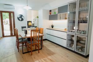 a kitchen with a table and a dining room at Casa di Samu in Bauladu