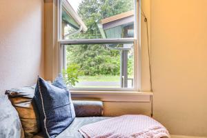 a window in a room with a couch and a pillow at Mt Rainier Retreat 7 Mi to Park Entrance! in Ashford