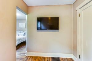 a bedroom with a flat screen tv on a wall at Mt Rainier Retreat 7 Mi to Park Entrance! in Ashford