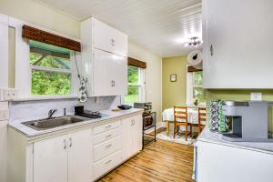 a kitchen with white cabinets and a sink at Mt Rainier Retreat 7 Mi to Park Entrance! in Ashford