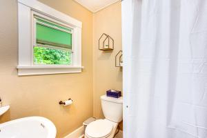 a bathroom with a toilet and a window at Mt Rainier Retreat 7 Mi to Park Entrance! in Ashford +17 photos
