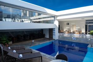 a swimming pool in the middle of a house at Arituba Park Hotel in Natal
