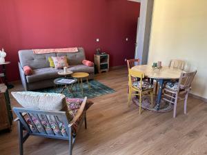 a living room with a couch and a table at L'Écrin des Arts - appartement avec jardin au coeur de la Côte des Blancs in Avize
