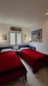 a bedroom with two beds and a painting on the wall at House Holiday Lodge in Žirje