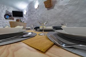 a table with plates and wine glasses on it at House Punat Residence in Punat