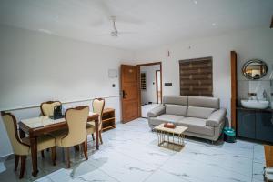a living room with a couch and a table at DQ Premium Apartments in Ernakulam