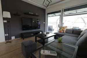 a living room with a couch and a table at Danka Pool House in Usije