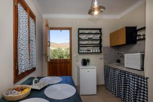 a kitchen with a table and a counter top at Κυκλαδίτικο studio στα Κιόνια in Kionia +13 photos