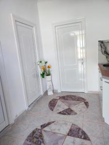 a kitchen with two doors and a tile floor at Guest house Eloid in Berat