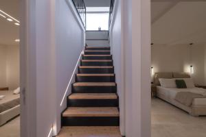 a staircase leading up to a bedroom in a house at Amalia Casa Lefkada in Pigadhisánoi +25 photos