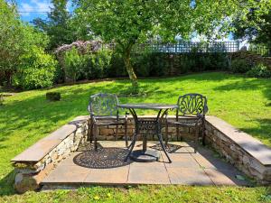 a table and two chairs sitting next to a table at Beebole Cottage in Askrigg +38 photos