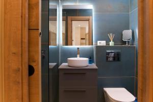 a bathroom with a sink and a mirror at Harbor Luxury - Apartment By Tarifa Rent in Tarifa +39 photos