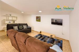 a living room with a couch and a table at OurMadeira - Casa da Belita, sea-view in Calheta