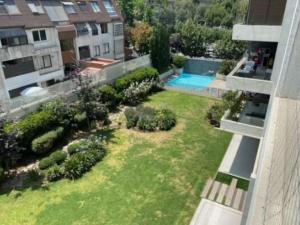 an aerial view of a yard with a swimming pool at Moderno depto 2D 2B con vista - 43 in Santiago