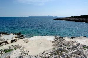 a beach with a large body of water at Foissner Apartments in Zavalatica