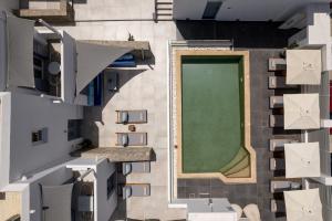 an aerial view of a building with a green lawn at Villa Kelly Rooms & Suites in Naousa