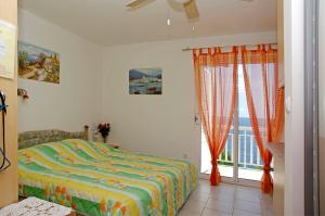 a bedroom with a bed and a large window at Foissner Apartments in Zavalatica