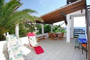 a patio with a table and chairs and a table and a table and chairs at Foissner Apartments in Zavalatica