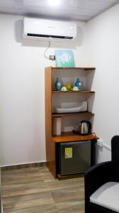 a room with a shelf with food on it at Coconut beach lodge in San Andrés
