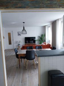 a living room with a table and chairs at Le reflet de la cathédrale in Saint-Omer