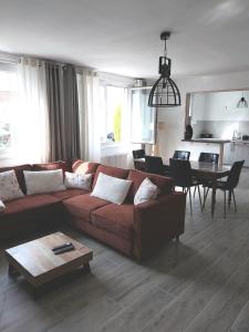 a living room with a couch and a table at Le reflet de la cathédrale in Saint-Omer