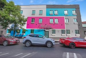 a row of cars parked in front of a building at Marina Hotel Brooklyn-Broadway in Brooklyn