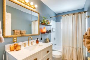 a bathroom with a sink and a toilet and a mirror at Near Shops and Eats Elegant Home in Wheat Ridge! in Wheat Ridge +20 photos