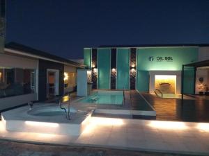 a house with a swimming pool at night at DEL SOL APART TERMAL II in Termas de Río Hondo