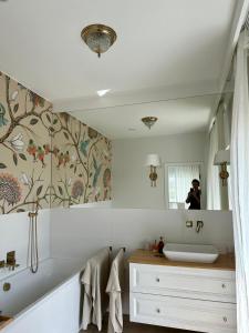 a person taking a picture in a bathroom mirror at Villa Mare in Gdańsk +29 photos
