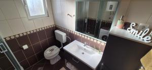 a bathroom with a sink and a toilet and a mirror at Apartment Magdalena in Sveti Filip i Jakov +23 photos
