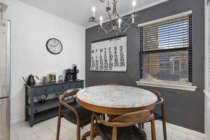 a dining room with a table and chairs and a clock at Ozark Retreat at the Pointe in Branson