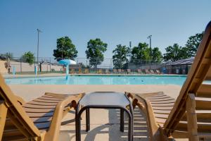 a table and chairs in front of a swimming pool at Ozark Retreat at the Pointe in Branson